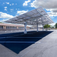 double cantilever commercial solar carport structure long shot view in church paring lot
