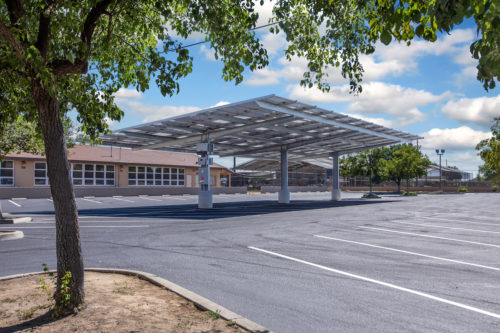 double cantilever commercial solar carport structure under view in church paring lot